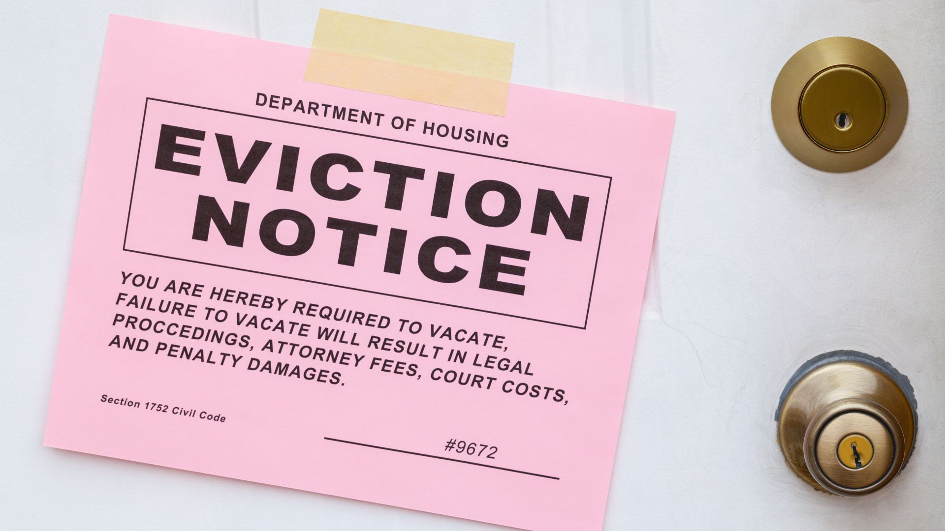 A white door with deadbolt lock and a large pink eviction notice