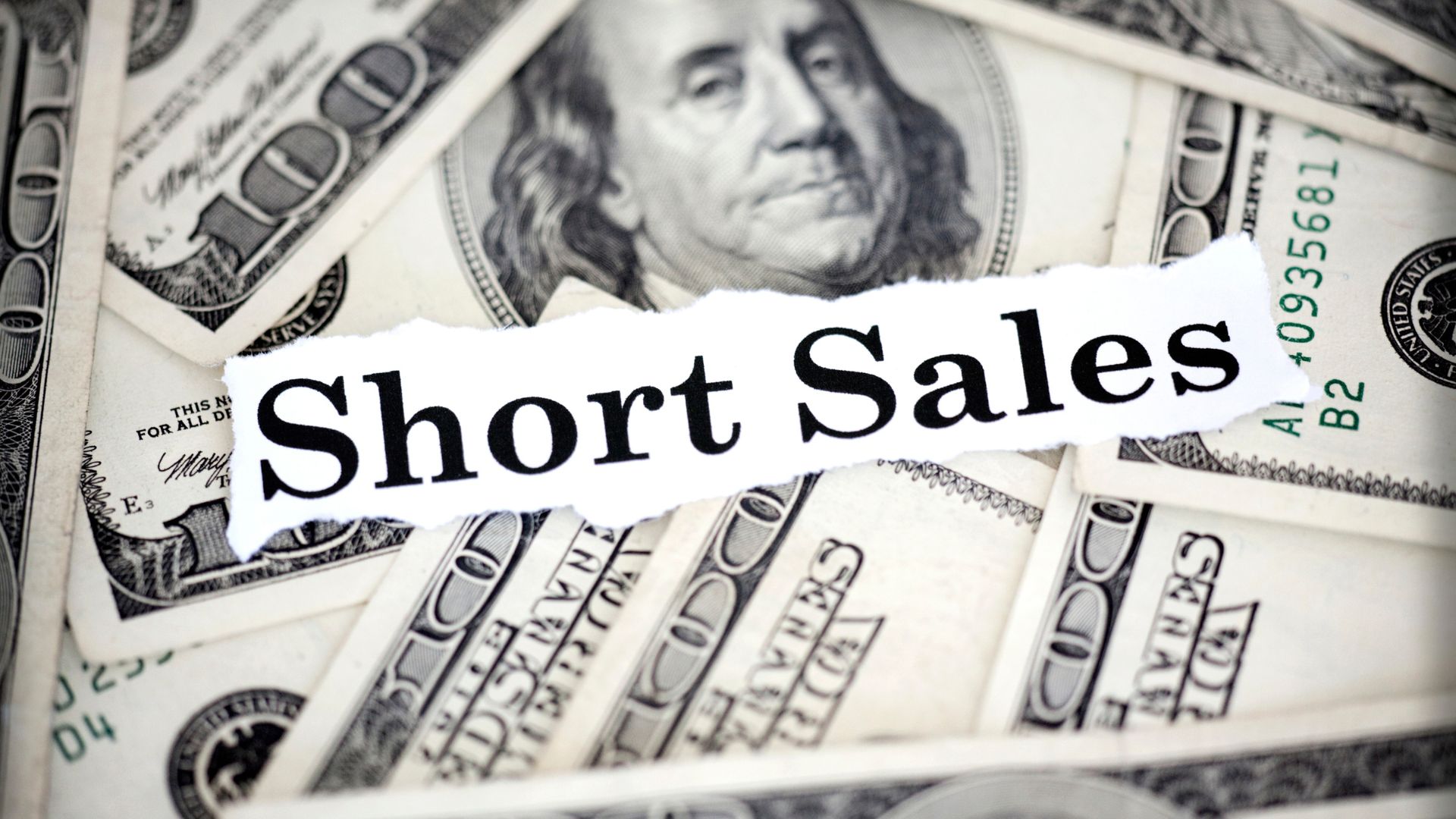 pile of money with the words short sale on top